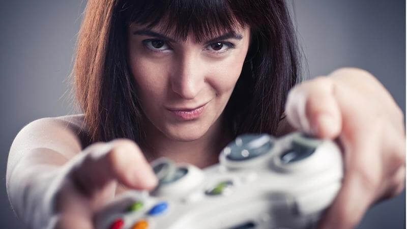 Girl playing videogames in a funny face