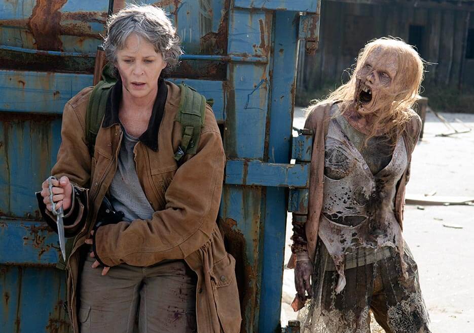 Carol about to be attacked by a walker