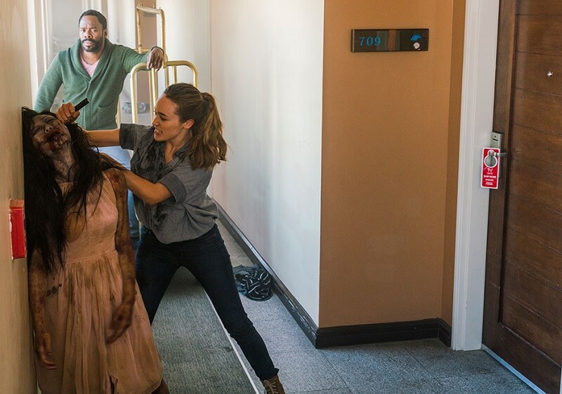 Alicia killing one of the infected while Strand looks bored