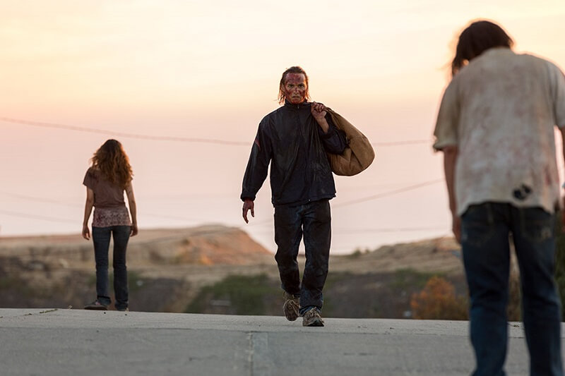 Nick walking down a highway hidden from the infected