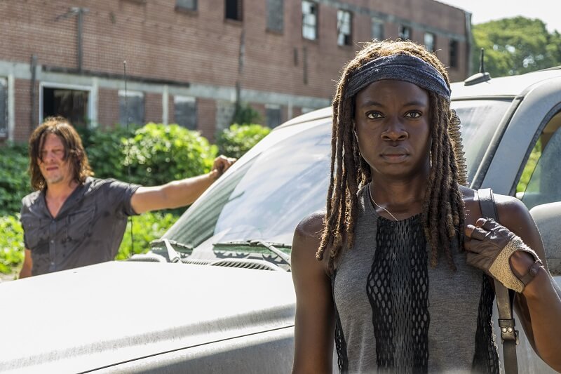 Michonne and Daryl standing outside their vehicle