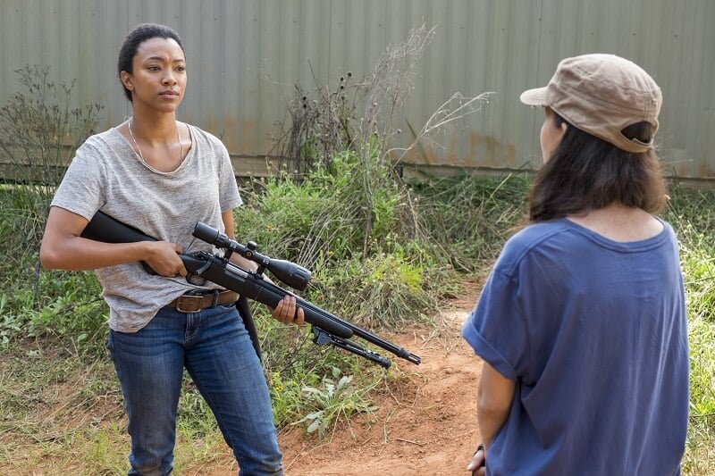 Sasha wielding a sniper rifle talking to Rosita