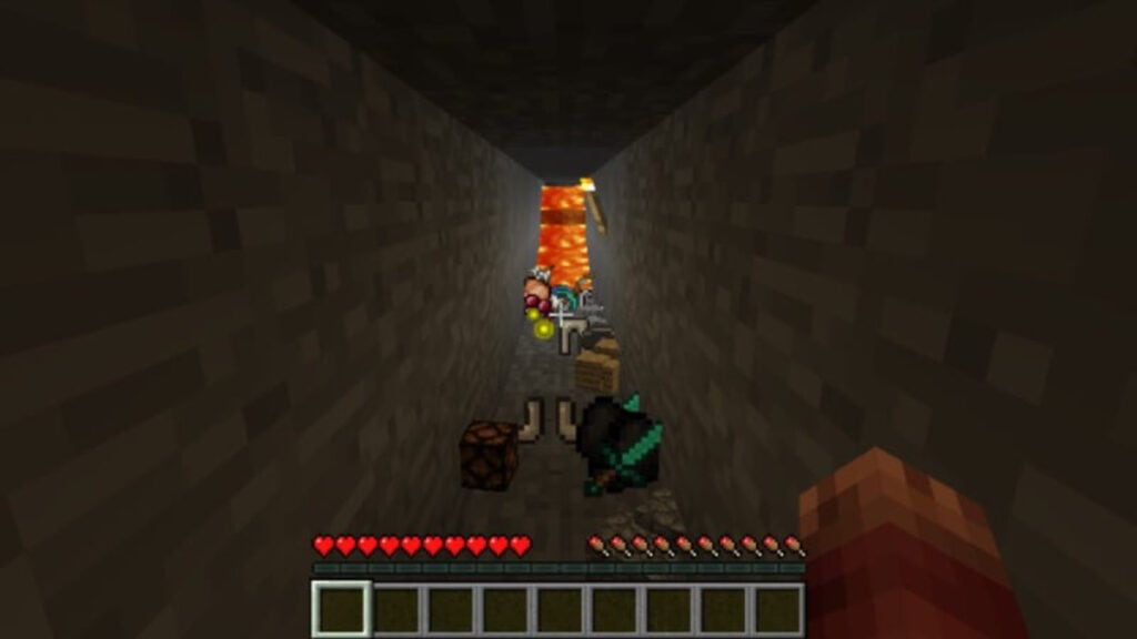 The player drops their items after death in a narrow tunnel in Minecraft