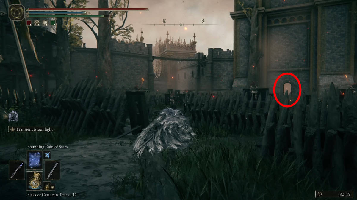 A player walks through a courtyard in Stormveil Castle.