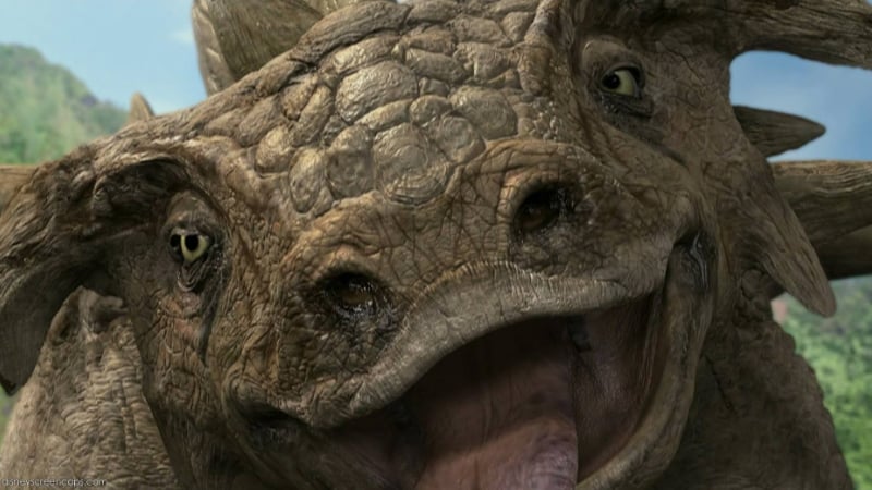 A close-up of a dinosaur smiling at the camera in Dinosaur