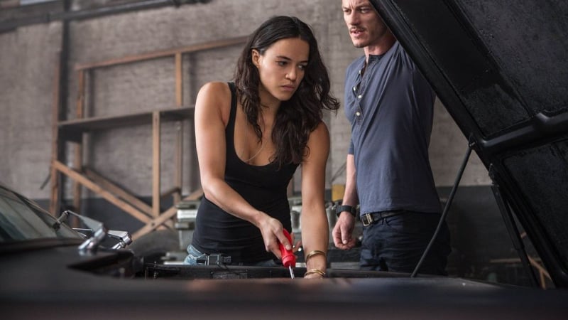 Michelle Rodriguez works on a car in The Fast and the Furious.
