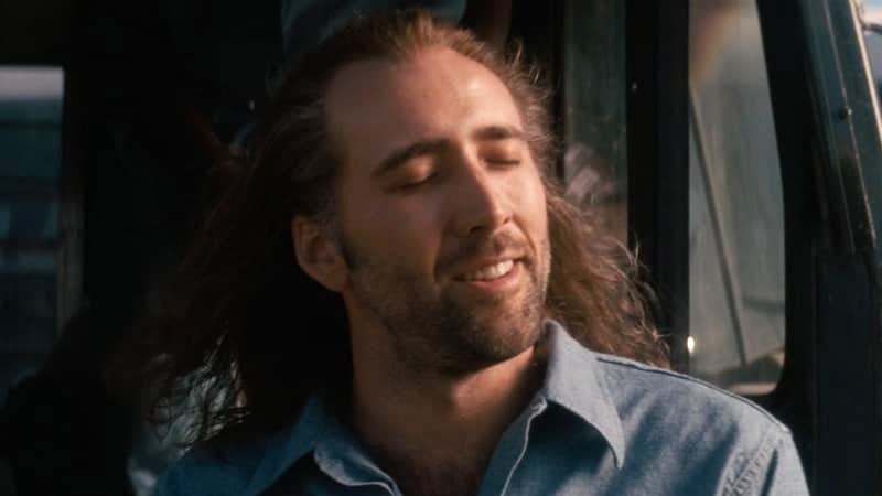 Nicolas Cage stretching his long hair in Con Air