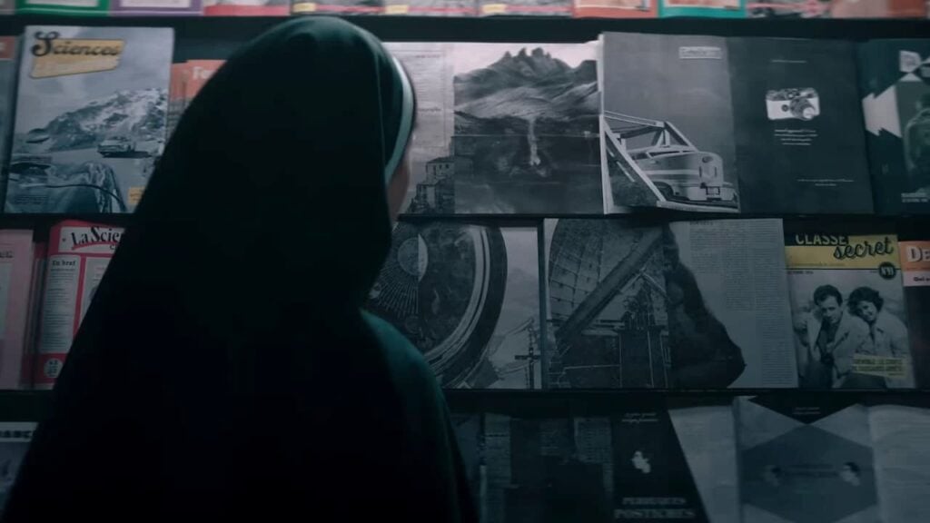 Does The Nun II Have a Post-Credits Scene? Sister Irene looking at Valak through magazines in The Nun II