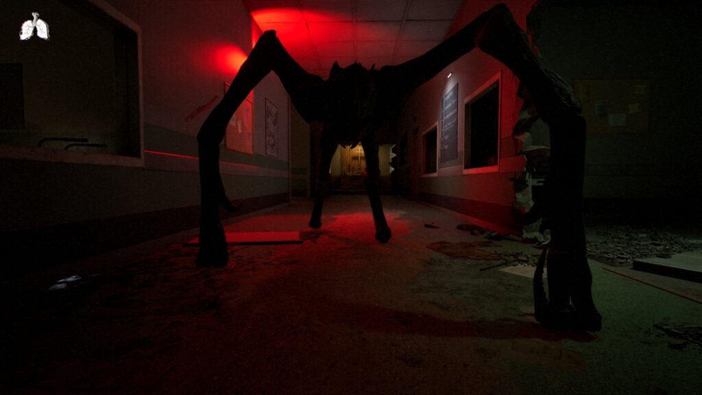 A creature looms over the player in a red-lit hallway
