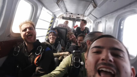 V/H/S/Beyond Review – Feverishly Fun Found Footage A group shot of the skydivers in Live and Let Dive, one of the segments in the horror anthology V/H/S/Beyond.