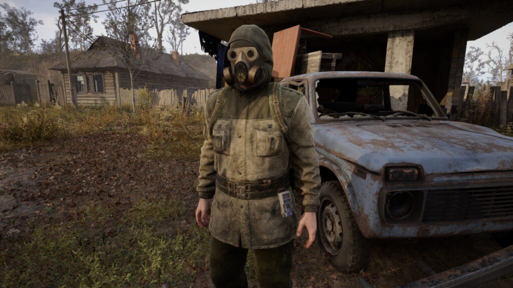 A lightly armored Stalker stands beside a junked car