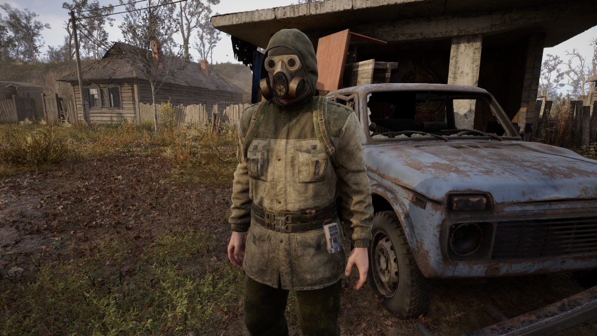 A lightly armored Stalker stands beside a junked car