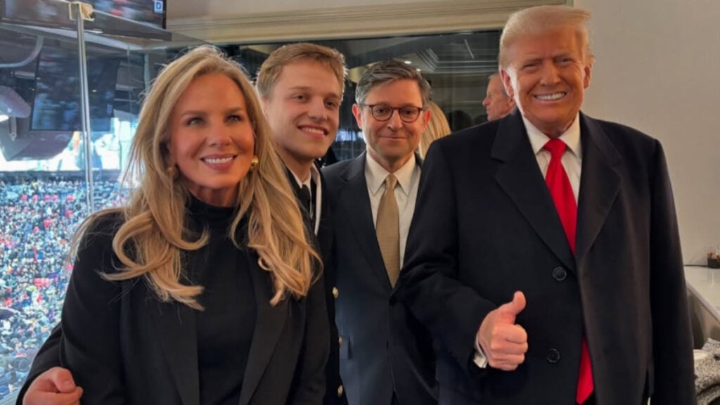 Speaker of the House Mike Johnson poses for a group photo with Donald Trump