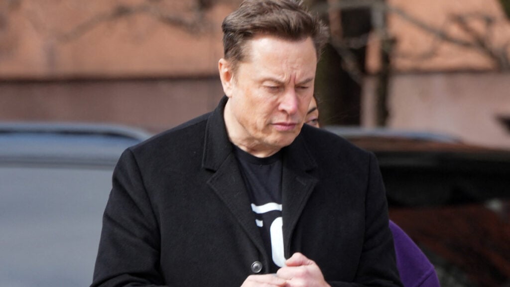 Elon Musk Pressured Reddit CEO To Censor Reddit: ‘I Think It’s Fair To Say Musk Is No Fan of Free Speech’ Elon Musk wearing a black coat.