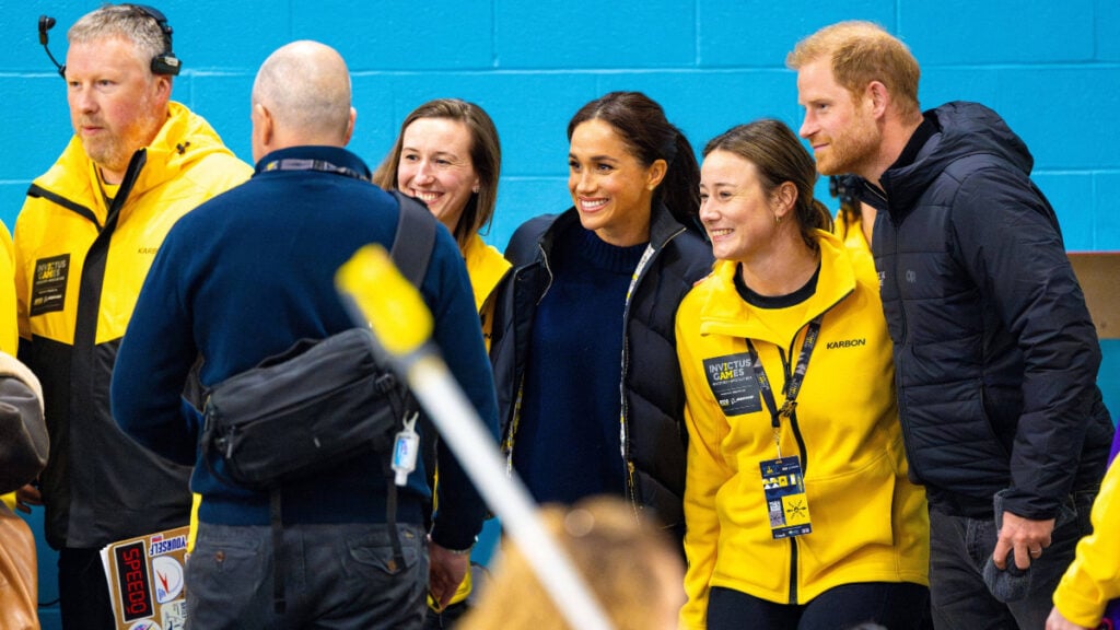 Prince Harry and Meghan Markle pose with team members at the 2025 Invictus Games in Vancouver.