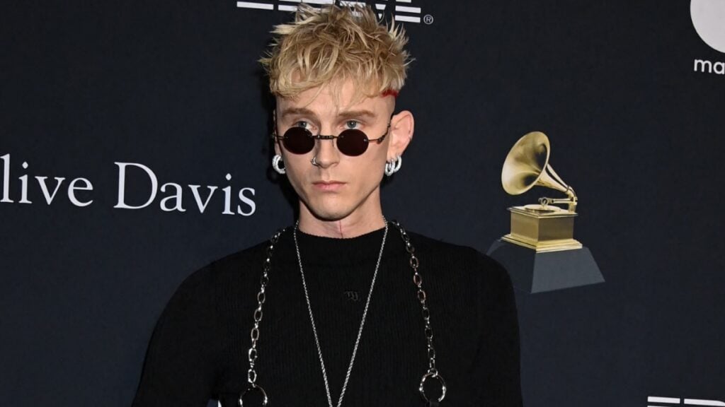 Machine Gun Kelly Swaps Megan Fox For Cara Delevingne and Taylor Swift At Super Bowl: ‘He’s Trading Up’ Machine Gun Kelly in all black