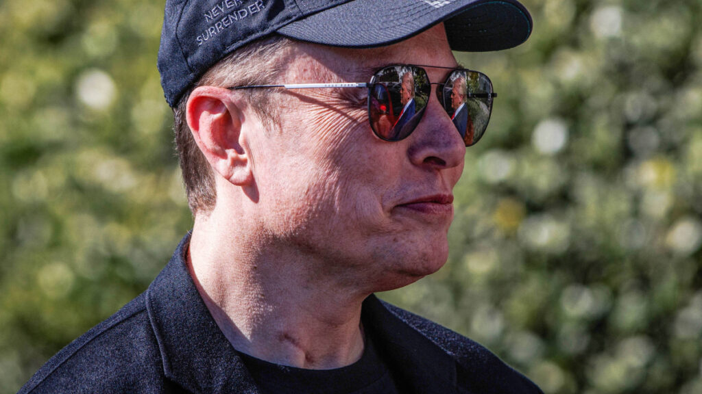 Tesla CEO Elon Musk in a black hat.