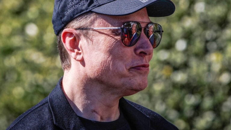 Tesla CEO Elon Musk in a black hat.