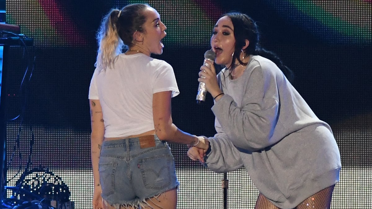 Miley Cyrus performs with her sister Noah Cyrus live onstage.