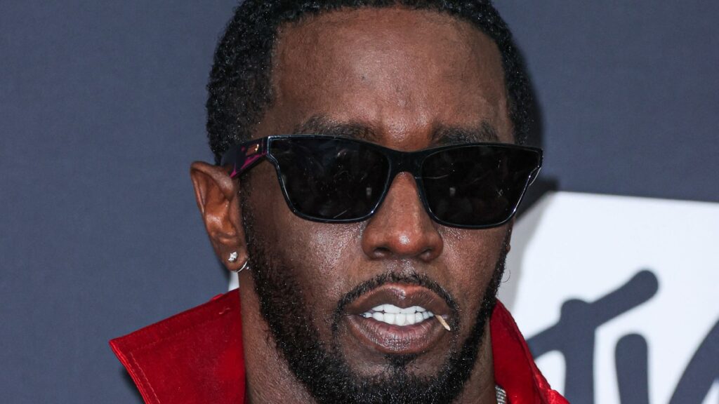 Photo of Sean Diddy Combs in a red outfit.