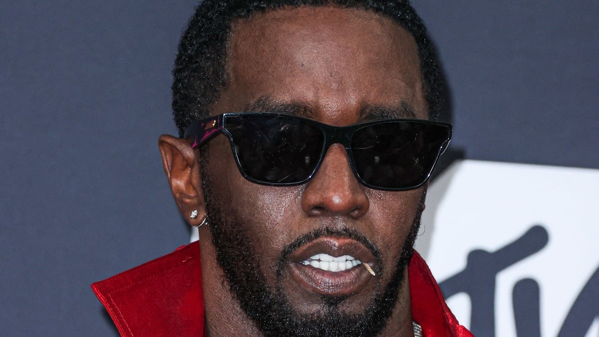 Photo of Sean Diddy Combs in a red outfit.