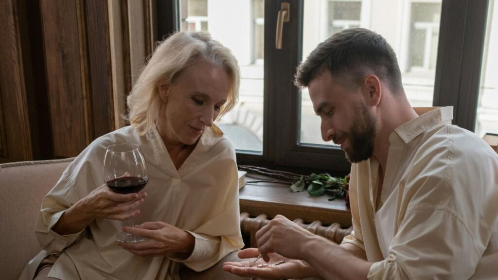 Man and woman enjoy date at home with wine