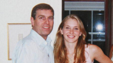 Prince Andrew smiling as he stands with his left arm around the waist of a young Virginia Roberts (now Virginia Giuffre). It is alleged to have been taken in early 2001.
