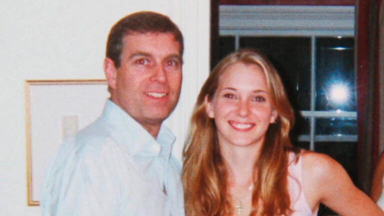 Prince Andrew smiling as he stands with his left arm around the waist of a young Virginia Roberts (now Virginia Giuffre). It is alleged to have been taken in early 2001.
