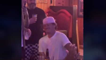 Tom DeLonge watches a fan preform his song in a California bar