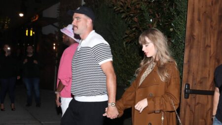 Taylor Swift and Travis Kelce holding hands