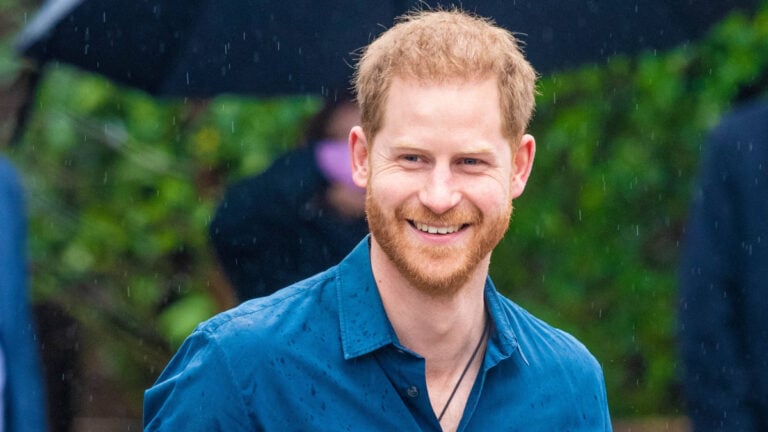 Prince Harry wearing blue shirt during a rainy day in Montecito, California.