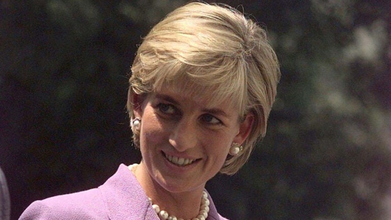 The late Princess of Wales, Princess Diana in purple suit.