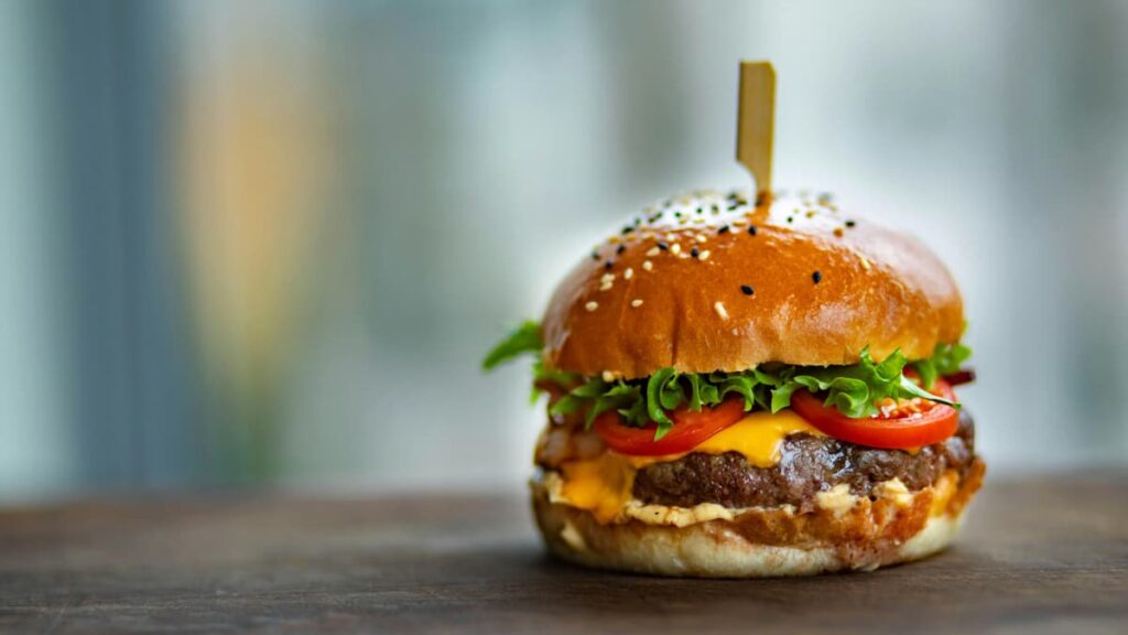 Texas Man Sues Burger Chain For Putting Onions on His Burger: ‘This Seems Intentional’ A picture of a burger in relation to the Texas man.