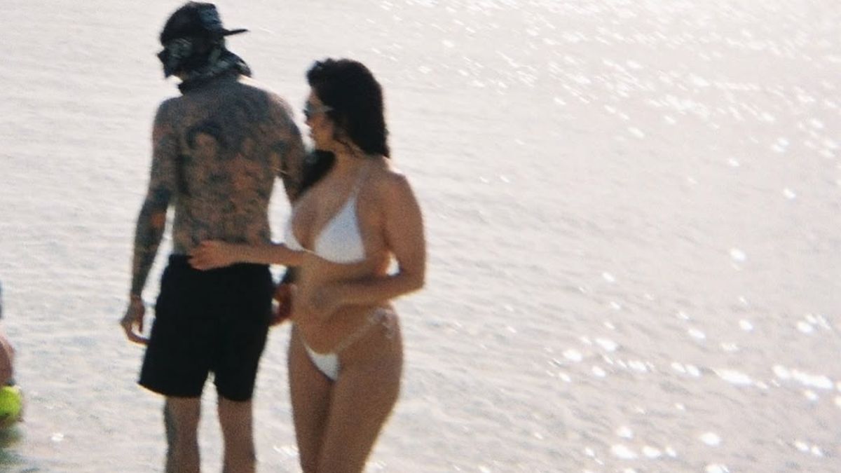 Kourtney Kardashian in a white bikini alongside Travis Barker