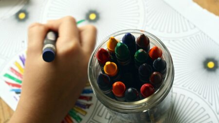 a child coloring with crayons