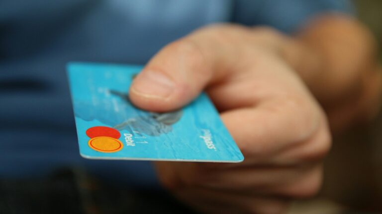 a person holding a bank card