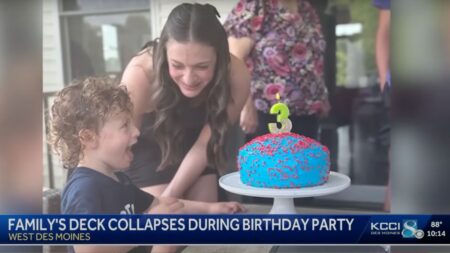 toddler blowing candles out at kid's birthday