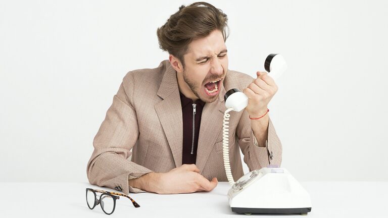 frustrated man shouting at phone