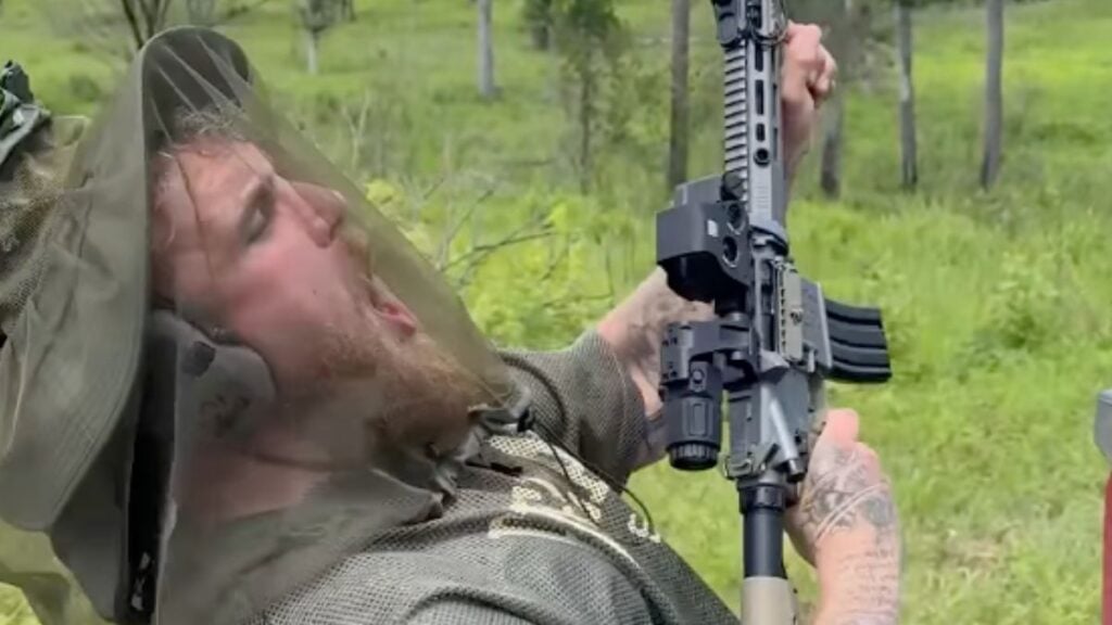 Jake Paul holding a gun