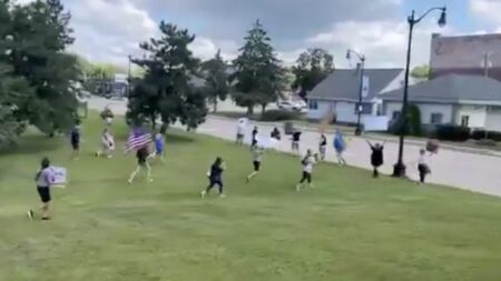 Protestors running on grass