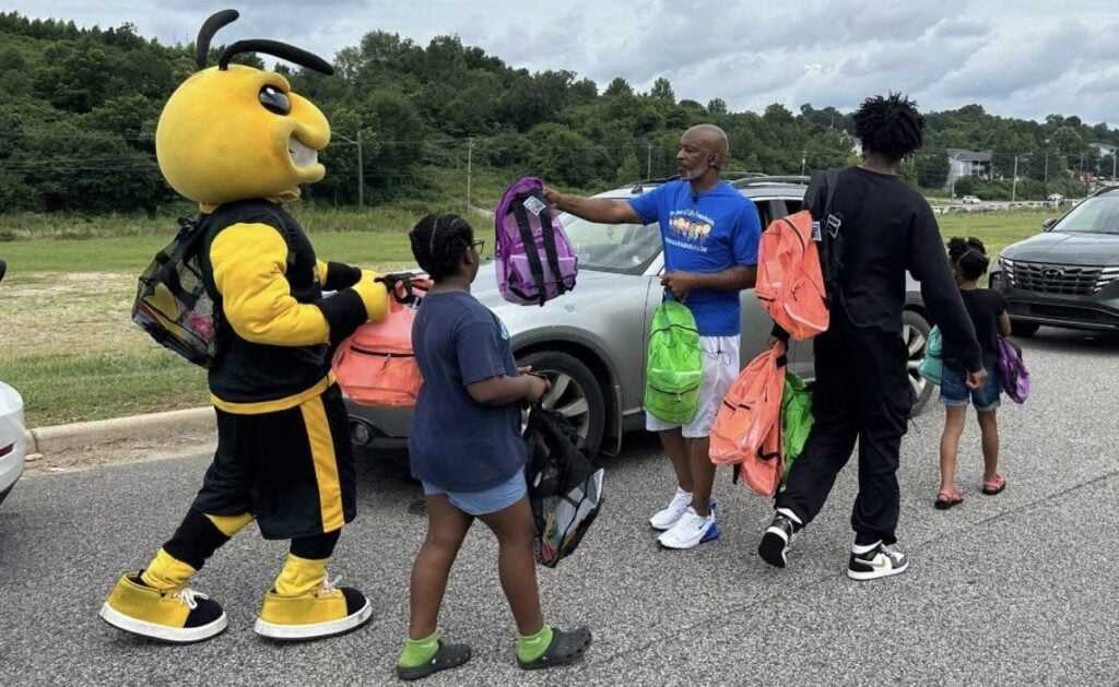 Lane Harper handing out school supplies