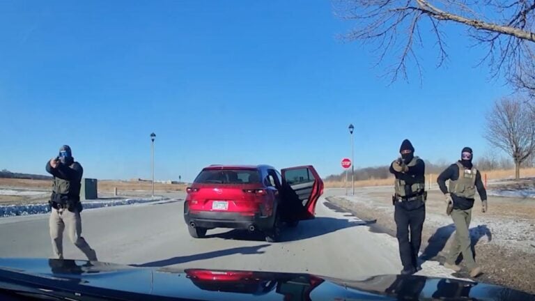 Dashcam video shows armed DHS agents surrounding an unarmed Minnesota woman inside her car.