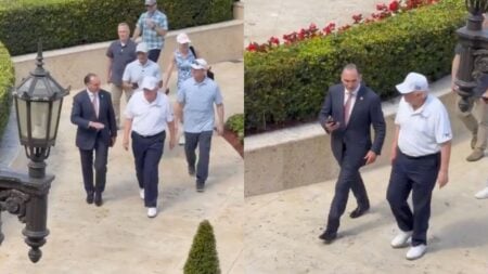 President Trump returning from a round of golf at Trump National Doral in Miami, Florida wearing a white USA baseball cap during the Iran war.