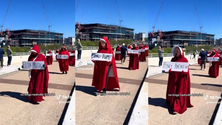 Protesters dressed in red Handmaid's Tale robes and white bonnets marching through downtown Nashville Tennessee during the No Kings Day protest on March 28 2026