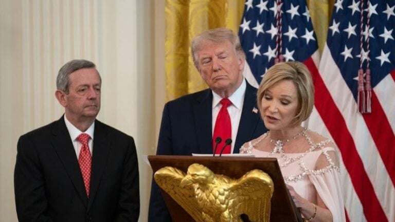 Paula White-Cain, senior adviser to the White House Faith Office, addresses President Trump from a podium in the White House East Room during an Easter lunch attended by more than 100 faith leaders.