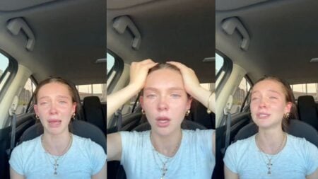 A young woman sits in the driver's seat of a parked car, visibly upset and emotional, speaking directly to her phone camera about the rising cost of gas and rent making it impossible to get ahead financially.