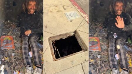 A handheld cellphone video filmed on Hollywood Boulevard near the Walk of Fame in Los Angeles, California, shows a homeless man named Jerry sitting inside a narrow opening in the sidewalk surrounded by personal belongings and debris.