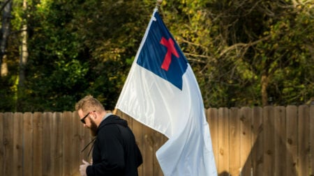 Man holding a Christian flag