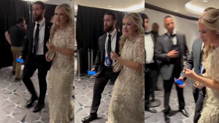 Erika Kirk, Turning Point USA CEO and widow of Charlie Kirk, is seen being escorted out of the Washington Hilton after shots were fired at the White House Correspondents' Dinner on April 25, 2026, visibly emotional and in tears.