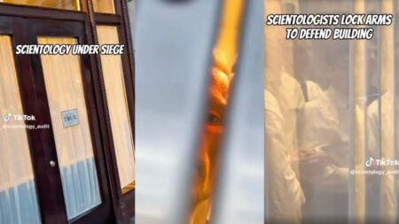 Scientology staff members are seen physically bracing against the doors of the Scientology Information Center on Hollywood Boulevard in Los Angeles, California, in an attempt to prevent viral speedrunners from entering the building.